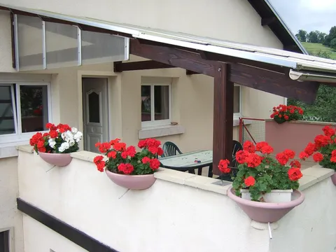 La terrasse couverte, sa table et ses géraniums